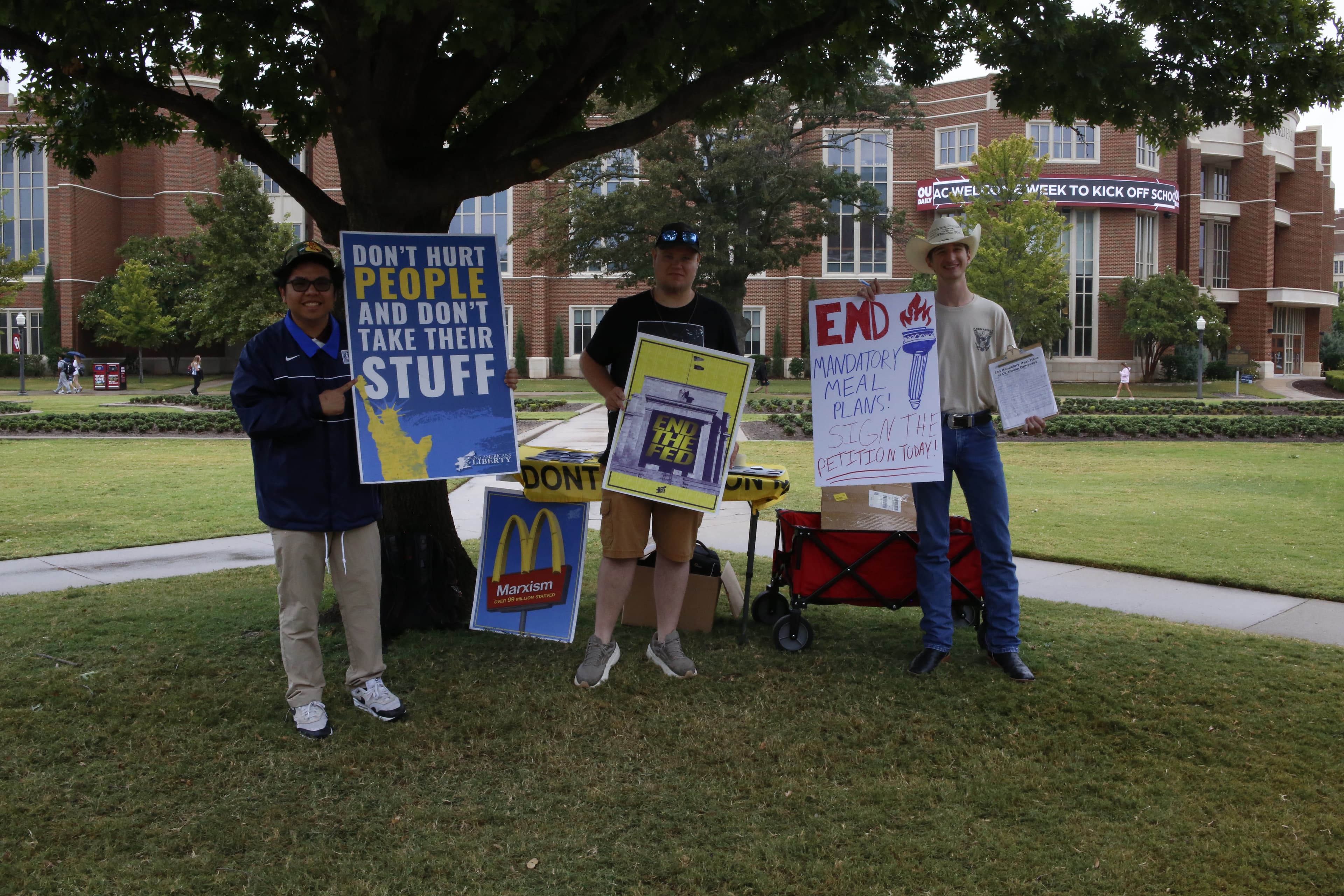 YAL students tabling on a campus quad with activism signs